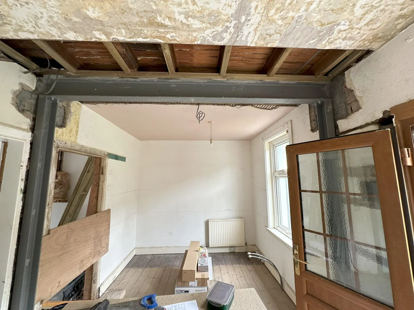 Interior wall opening mid-renovation with steel beam in place